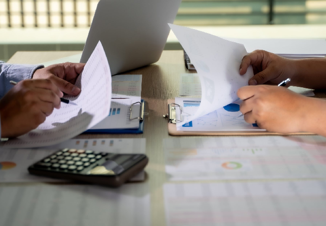 Professionals working in office with documents on hand